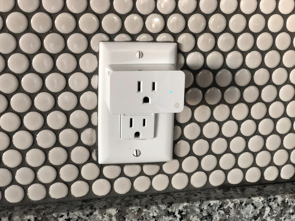 White electrical outlet on polka dot wall