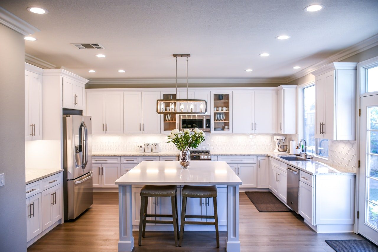 Clean white kitchen with hardwood floors