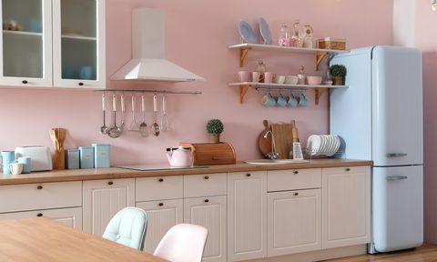 Stylish 1920's pink kitchen interior with dining table and chairs