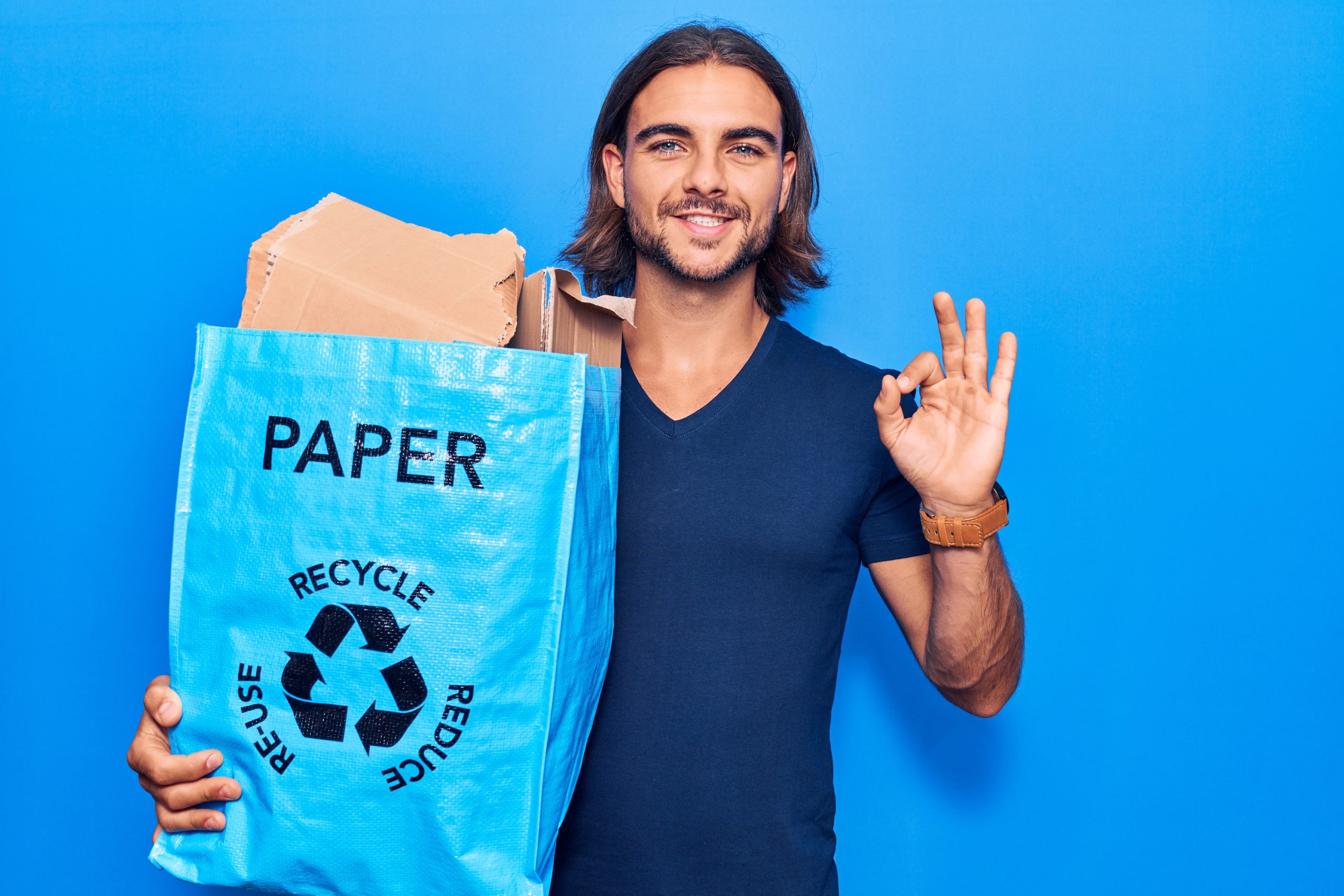 Man holding a bag of recycled paper