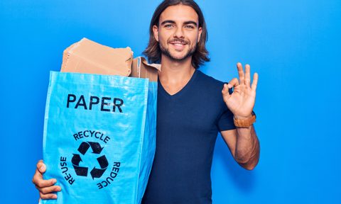 Man holding a bag of recycled cardboard