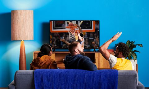 Three men watch a basketball game on TV