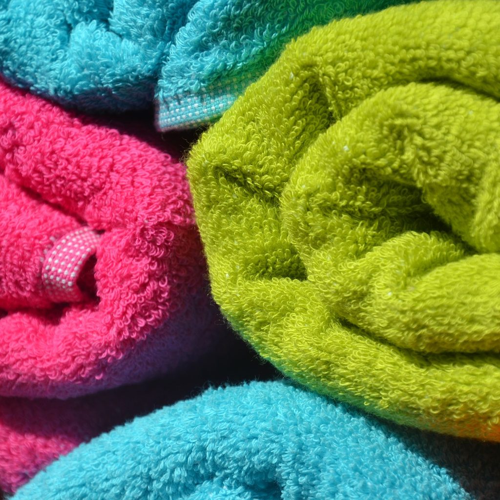 A variety of colorful towels rolled up