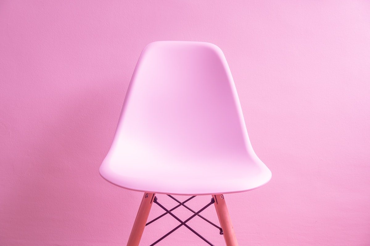 Pink chair against a pink wall