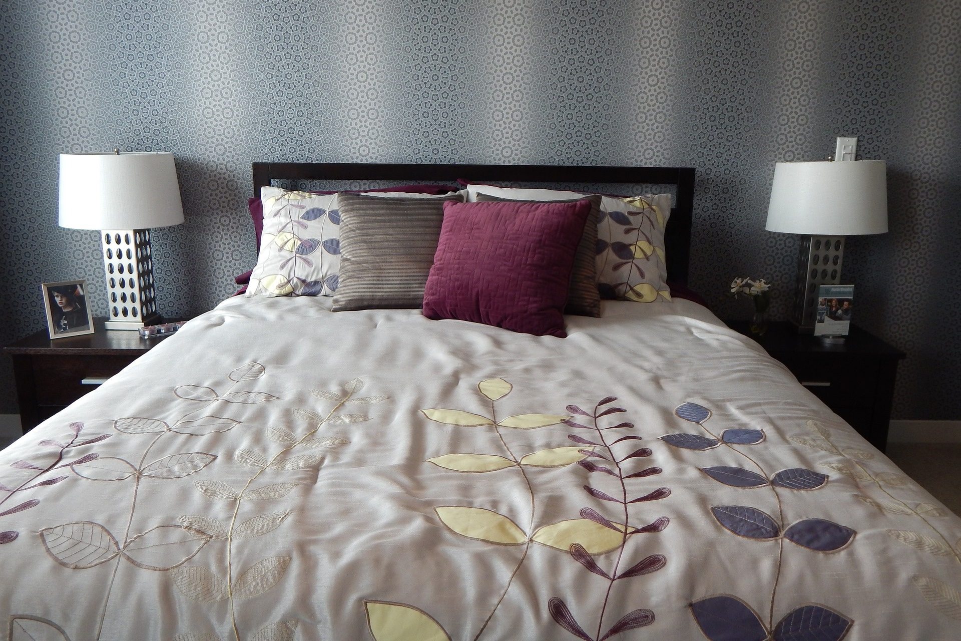 gray bed with patterned spread