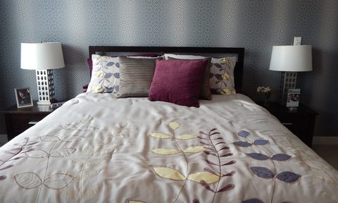 gray bed with patterned spread