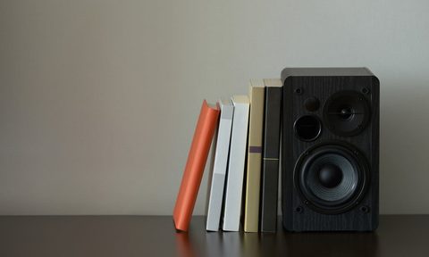 speaker on shelf next to books