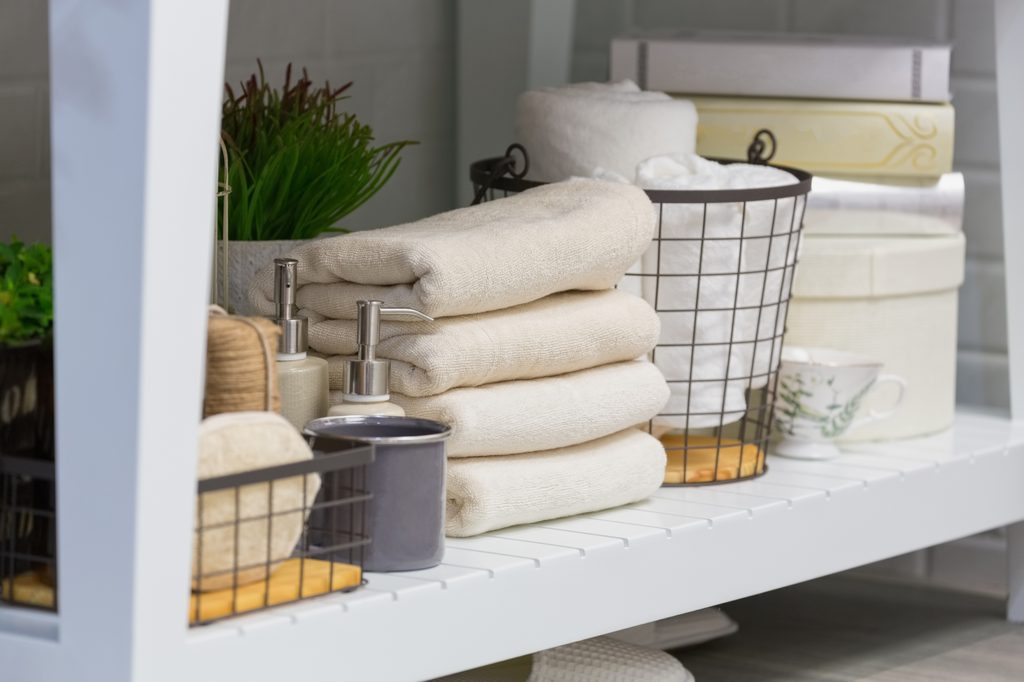 Folded towels on a bathroom shelf