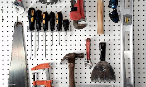 Pegboard with tools hanging on it