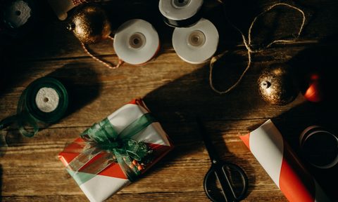 Holiday wrapping materials on wooden table top