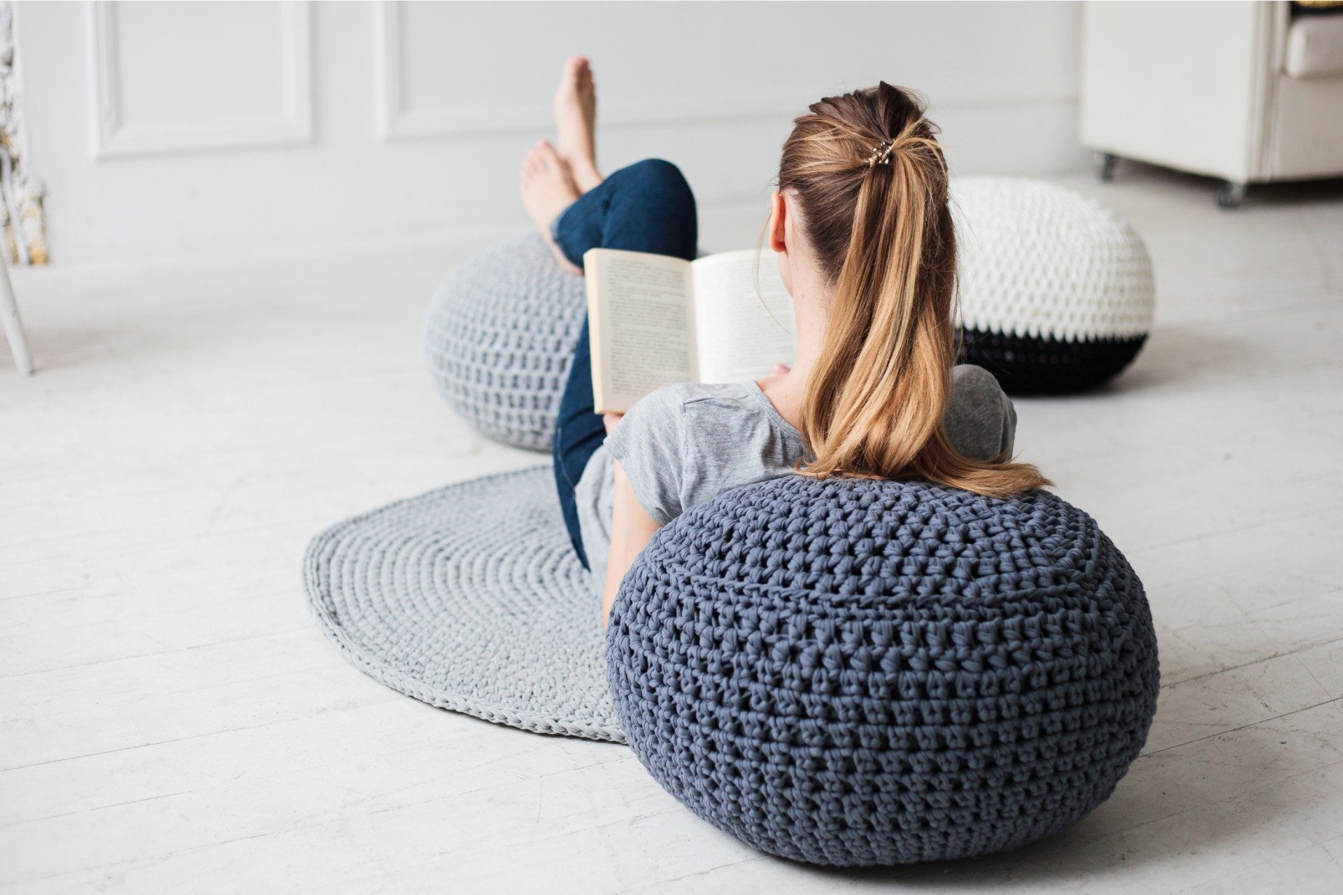 women using pouf as footrest