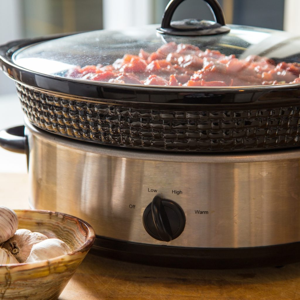 Slow cooker on table with food