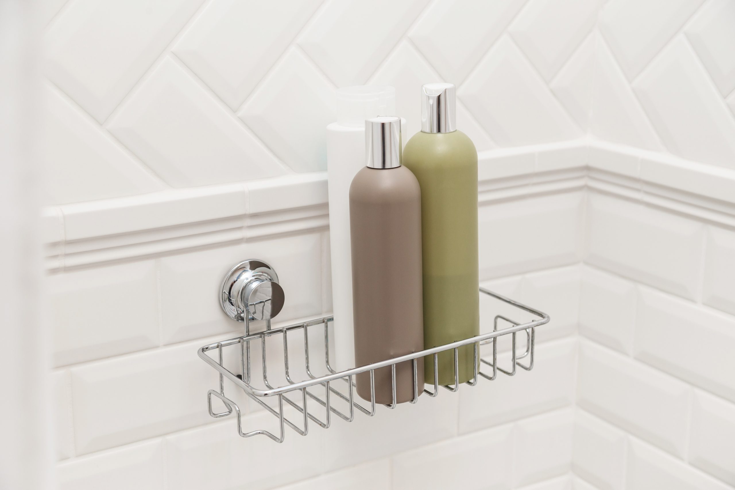 Shower caddy suctioned to bathroom tile