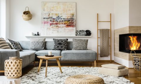 Living room with couch, rug, and fireplace