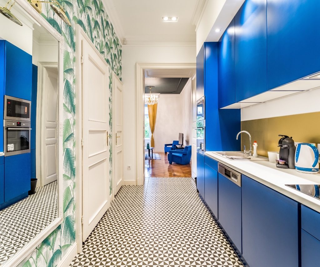 A galley kitchen with blue cabinets