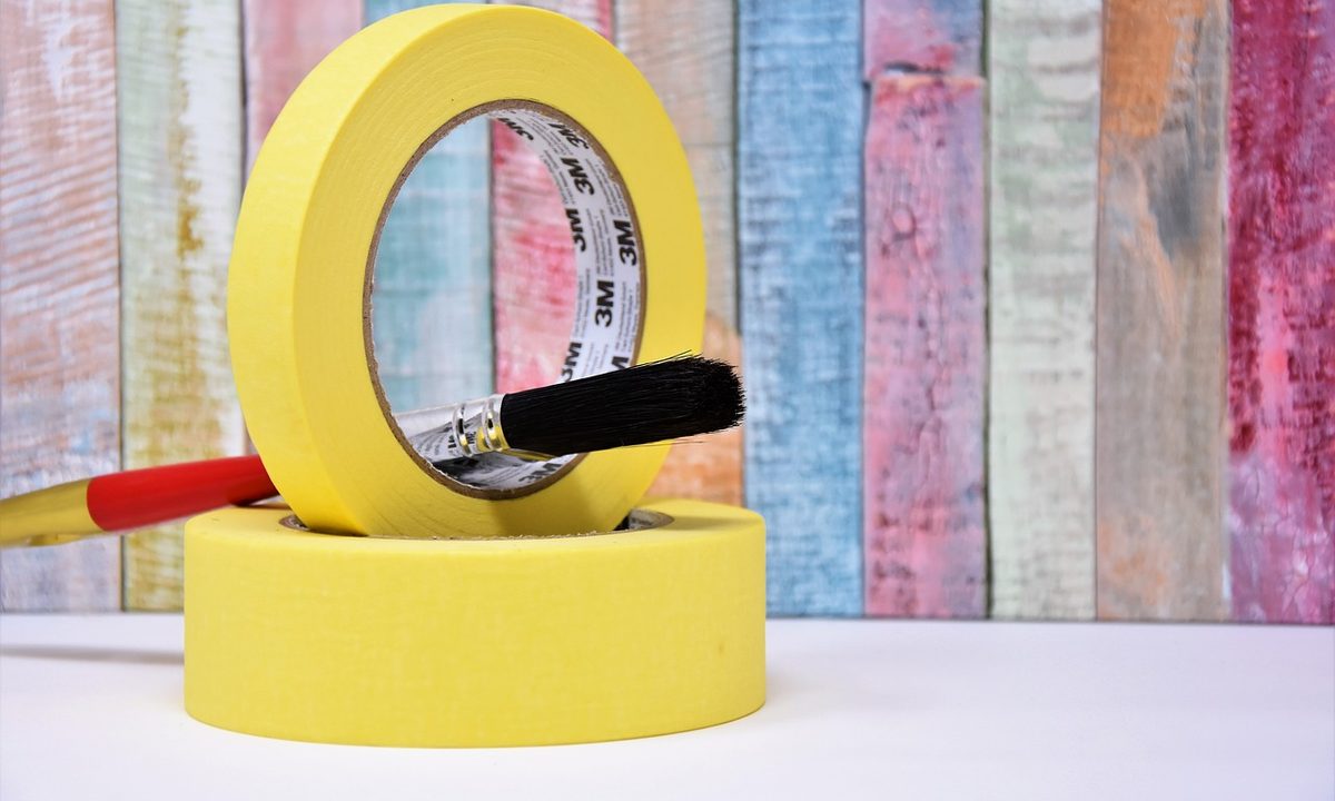 Yellow painter tape with red paint brush