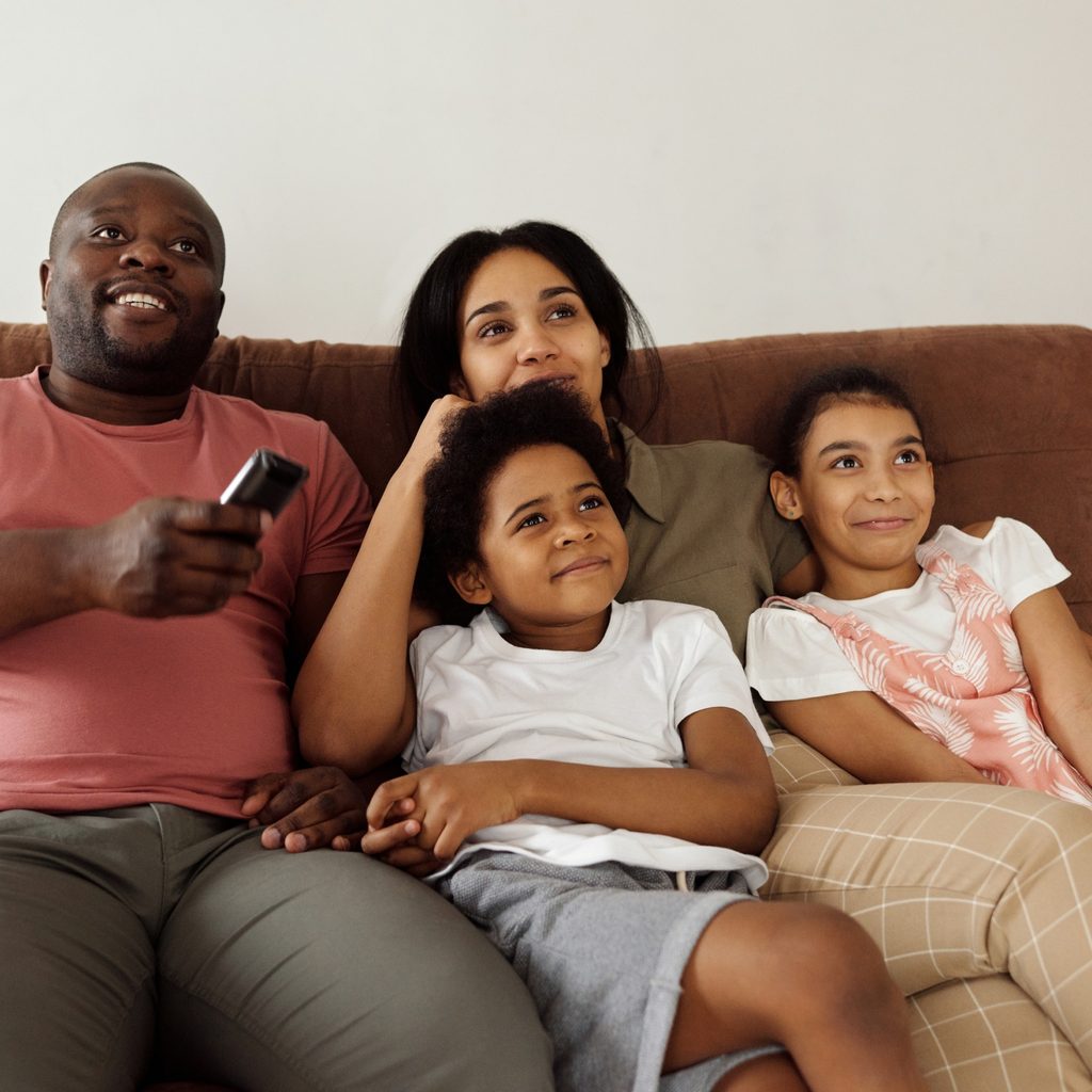Family Sitting On A Brown Couch