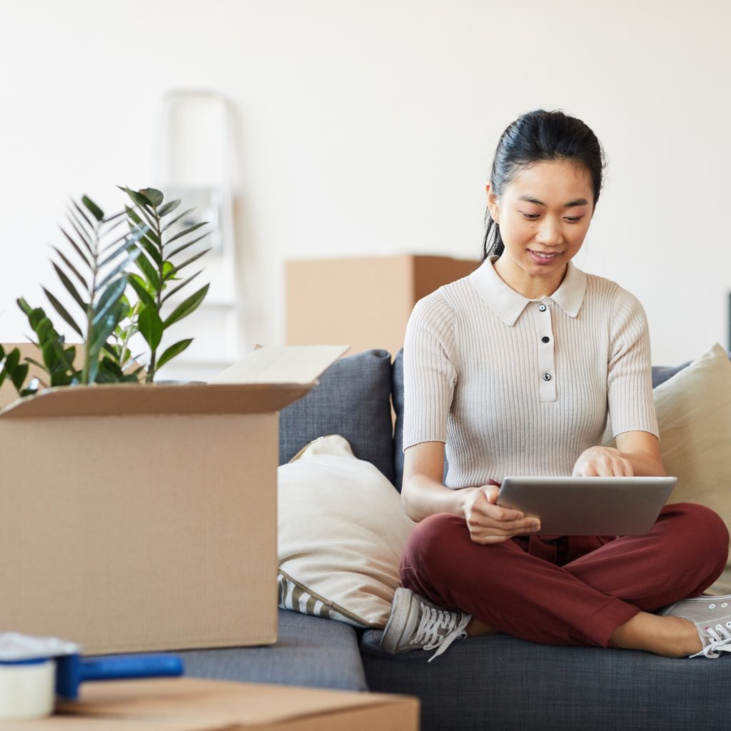 Woman decluttering with boxes around her