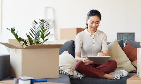Woman decluttering with boxes around her