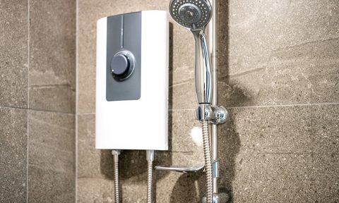 Tankless water heater next to a shower