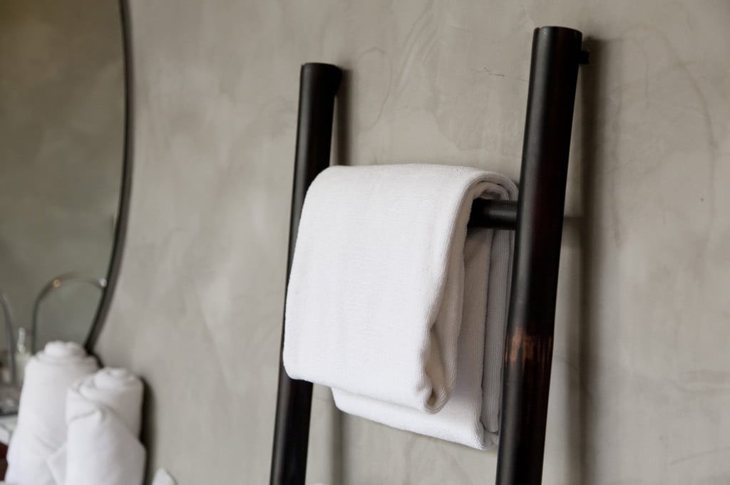 white towel hanging on bathroom towel ladder