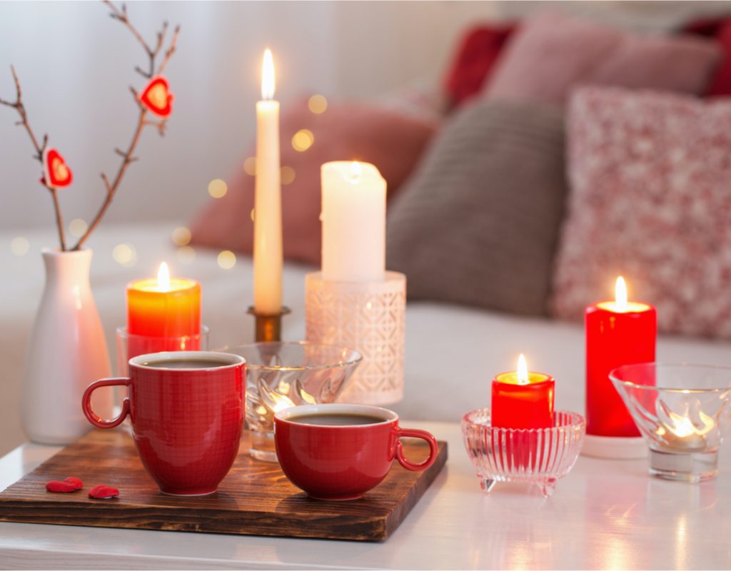 Candles with red cups on coffee table
