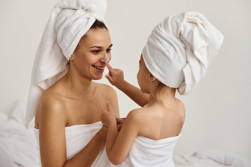 Mother and daughter in bath towels after shower