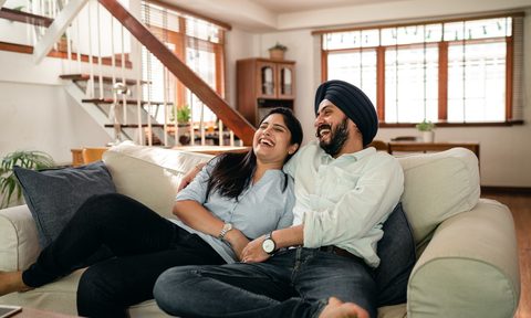 couple watching comedy movie on couch