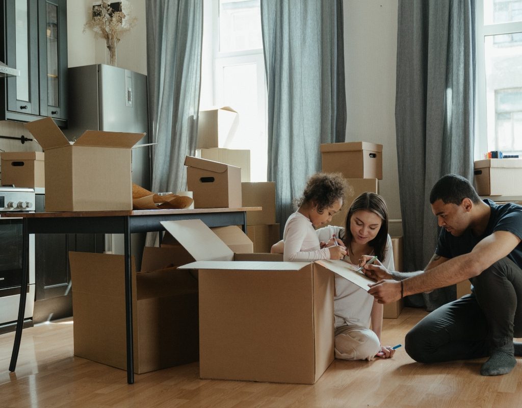 family packing boxes in living room