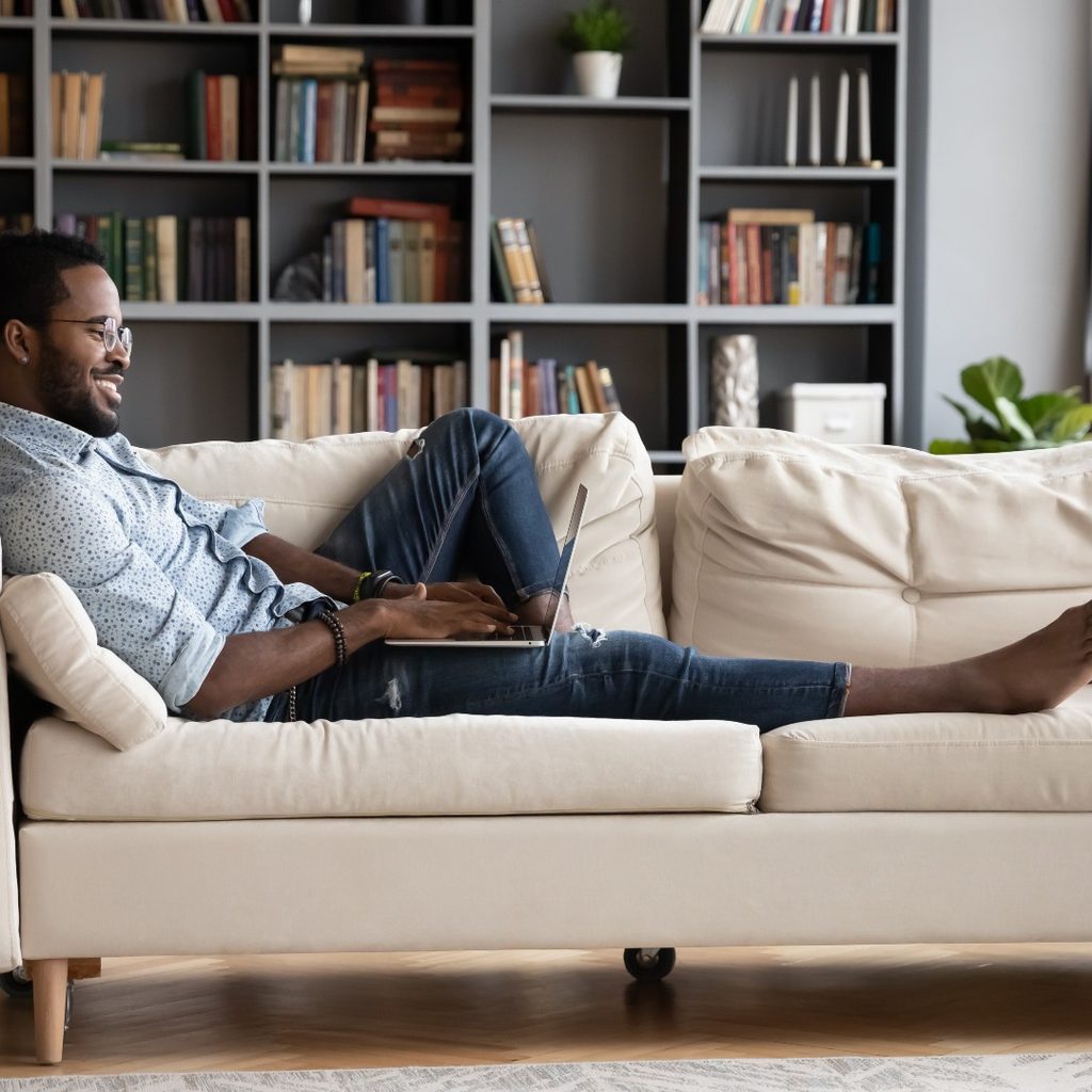 man lounging on couch
