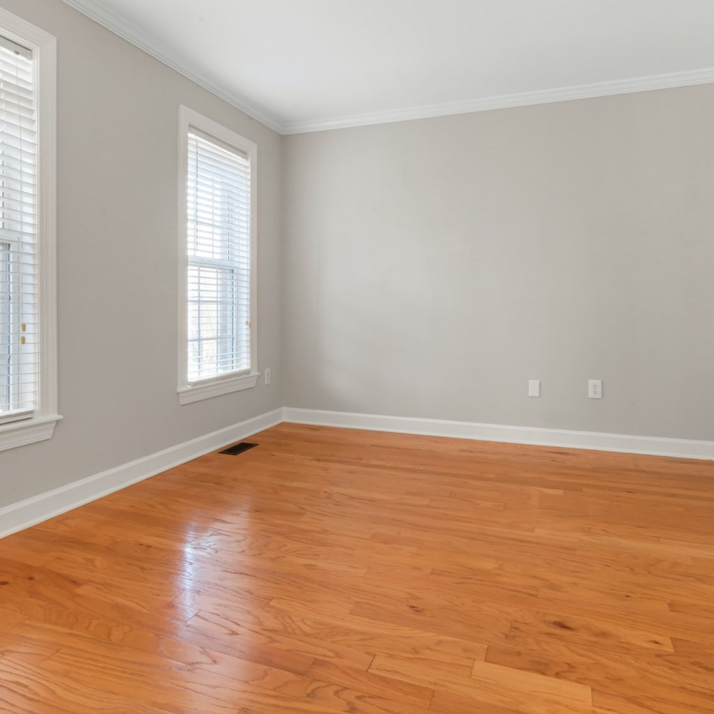 neutral room with wood floor