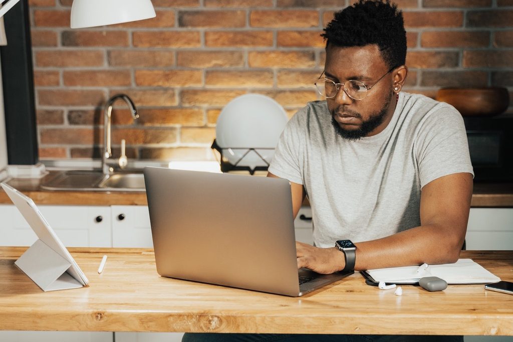 man with computer at table