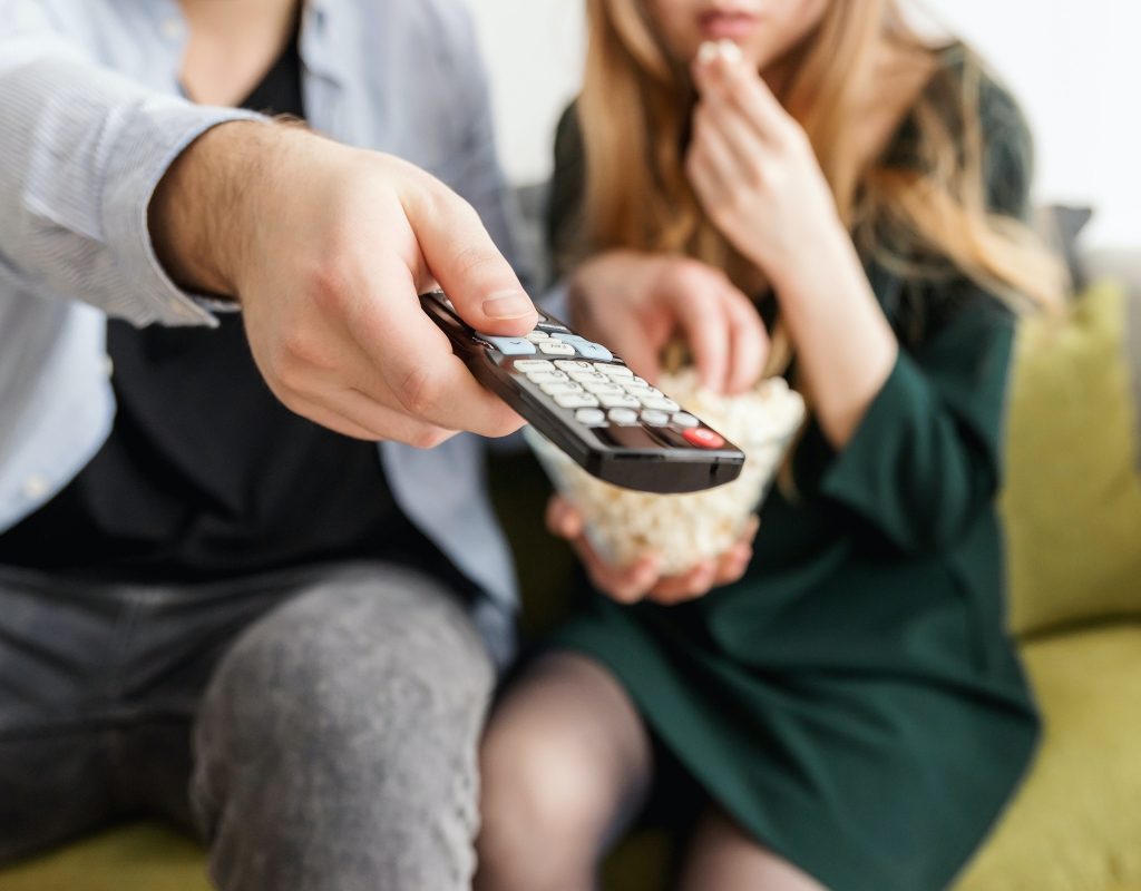 Couple holding a TV remote