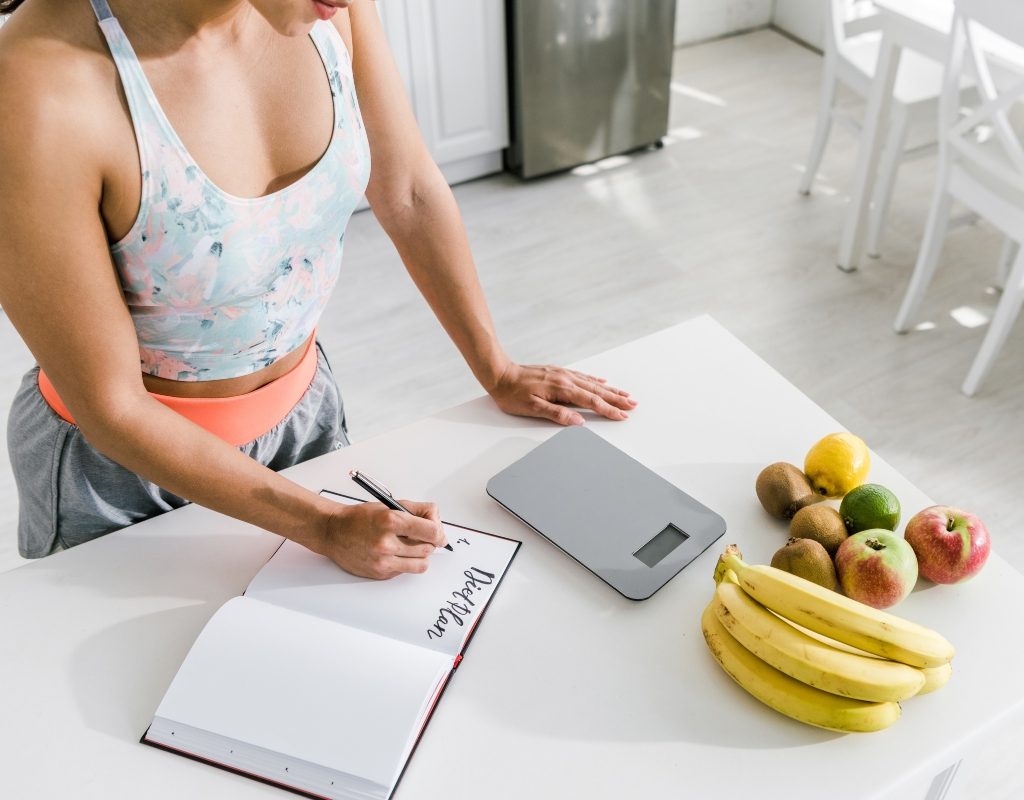 woman using a kitchen digital scale