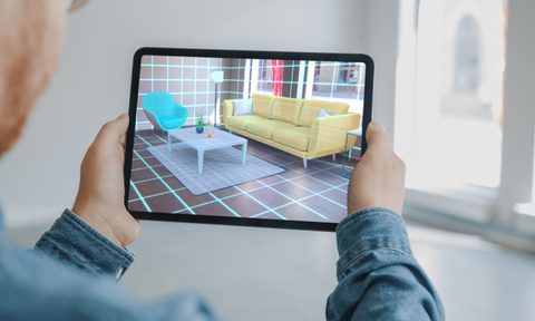 Man Holding Tablet With Home Design App