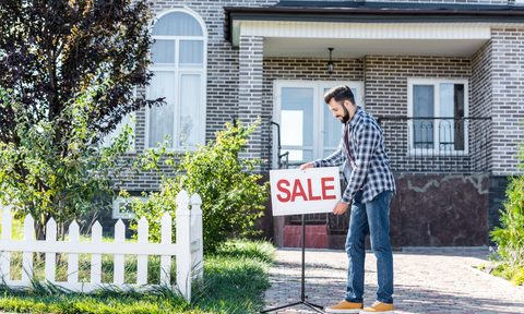 man in front of house for sale