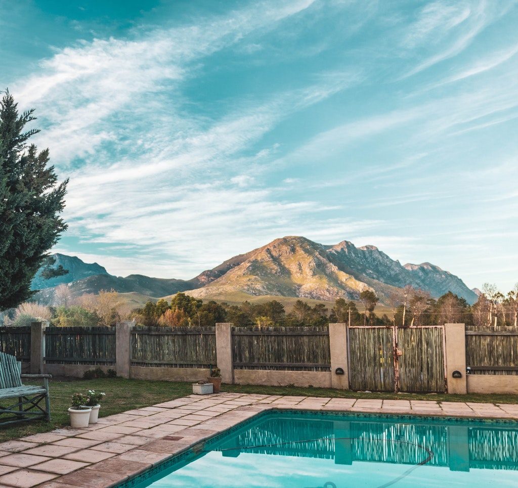 Backyard inground pool with mountain in the background