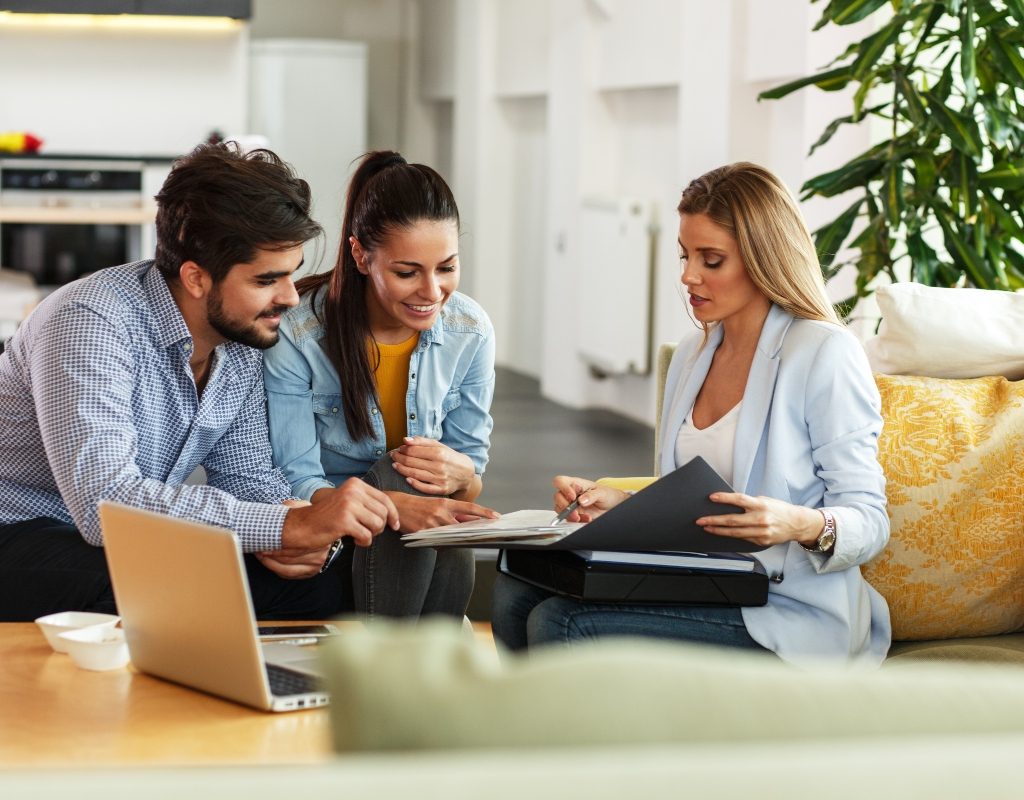 real estate agent talking to homeowners