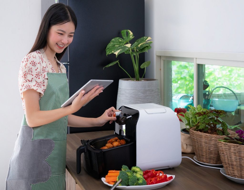 woman cooking with an air fryer