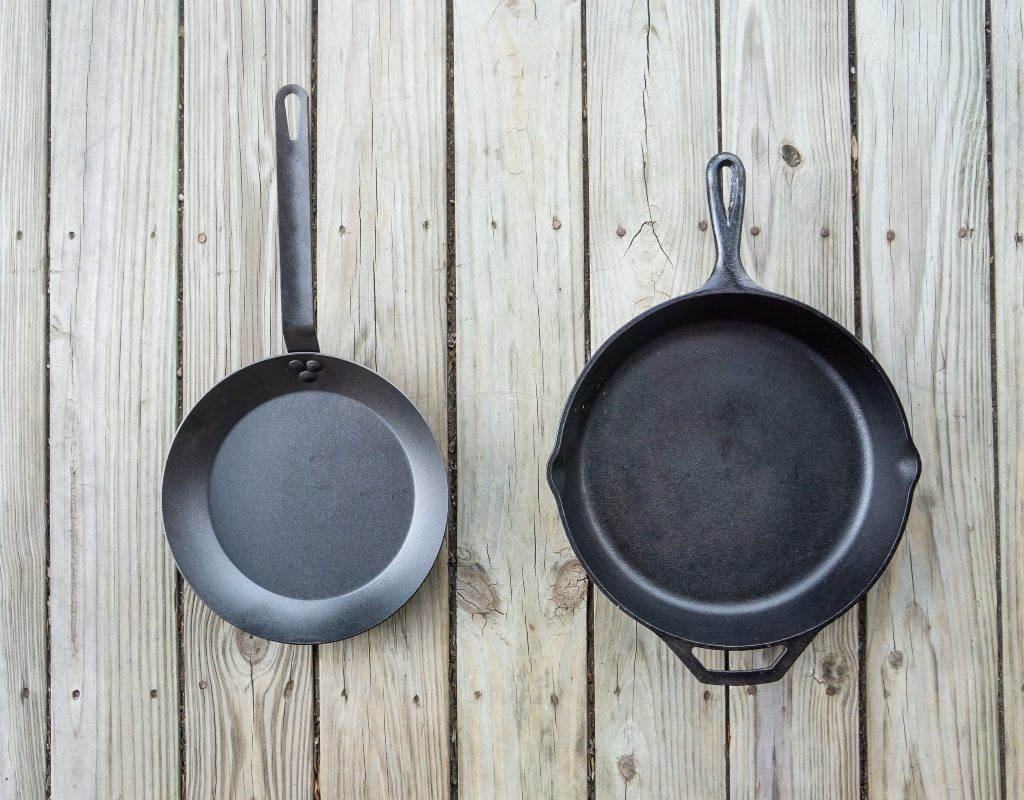 cast iron pan beside carbon steel pan comparison