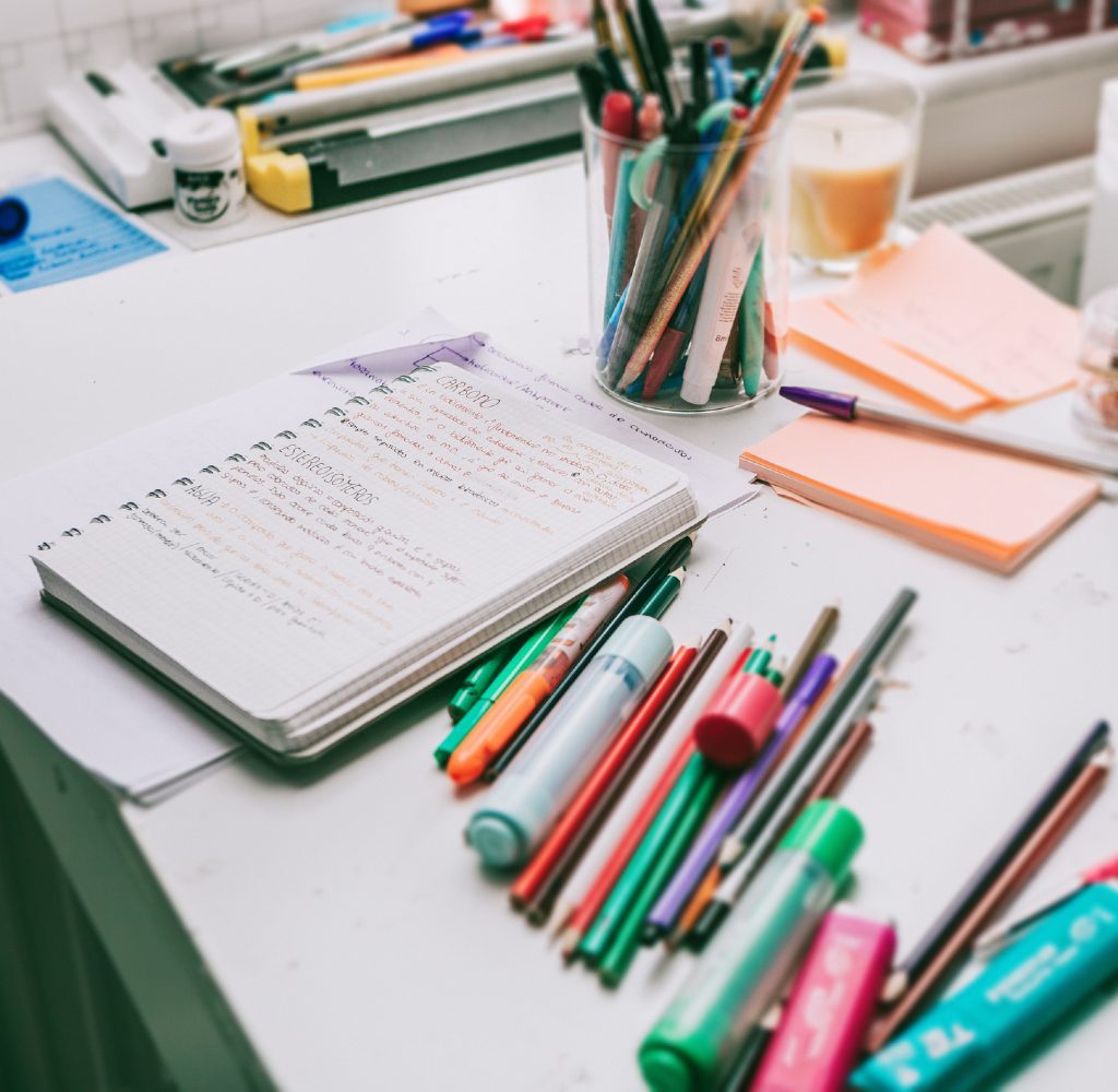 Desk with office supplies scattered about