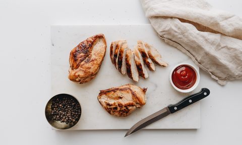 cut chicken breast on counter with knife