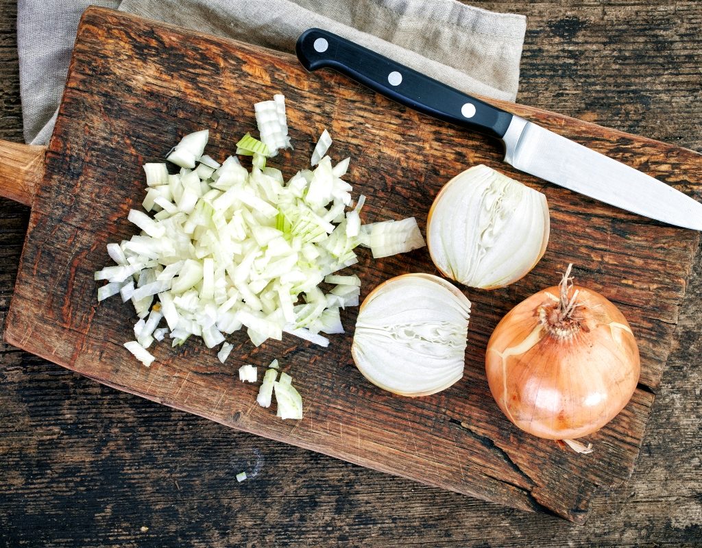 diced onion on cutting board next to knife