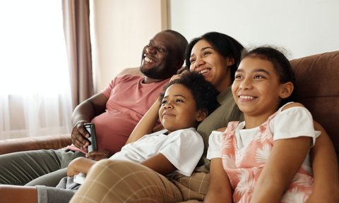 Family watching TV together on the couch
