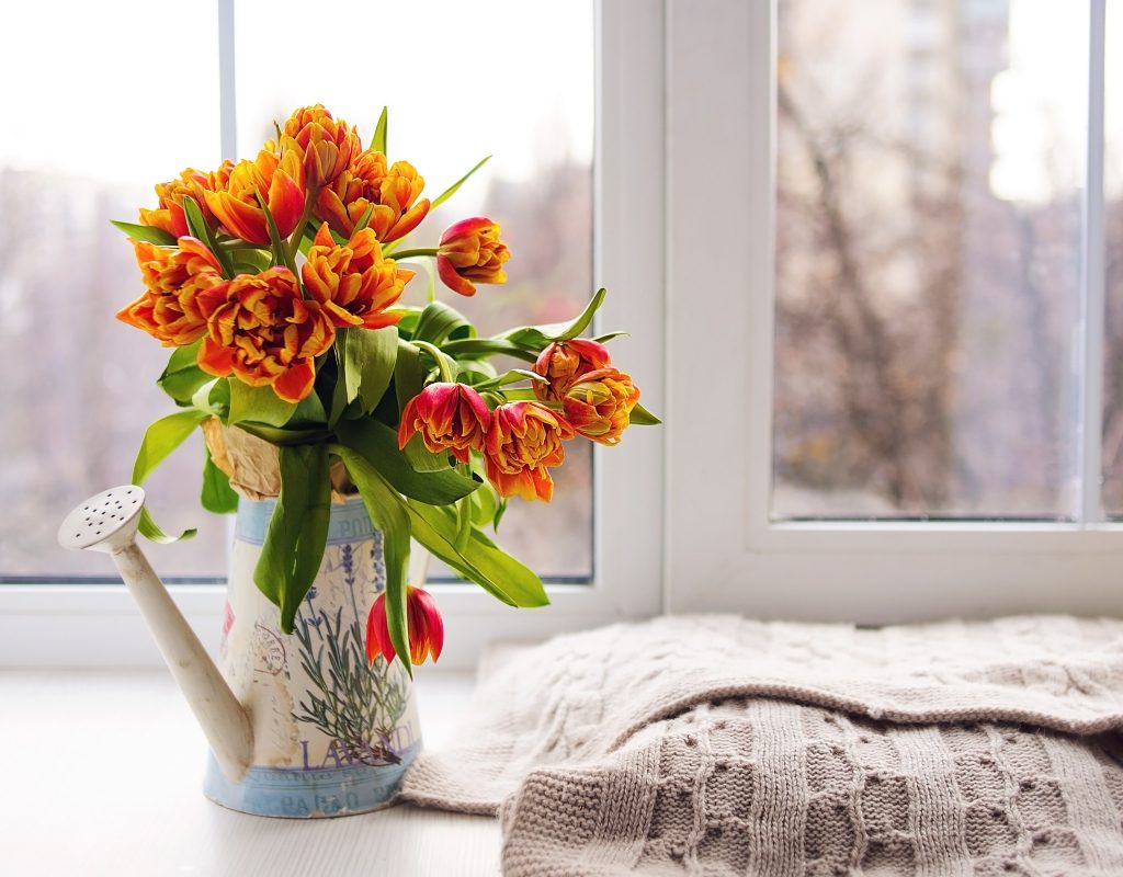 orange flowers in a watering can