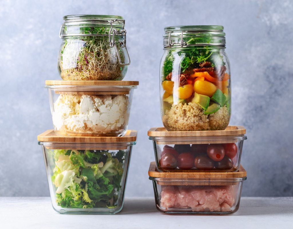 Glass storage containers stacked on a white surface.