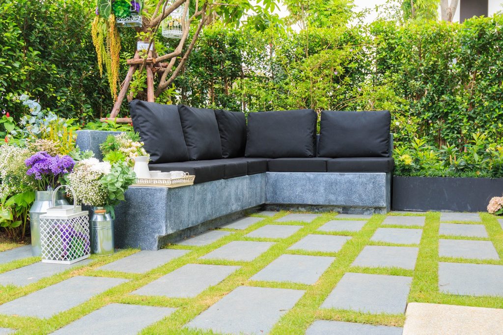 Concrete patio with grass between pavers