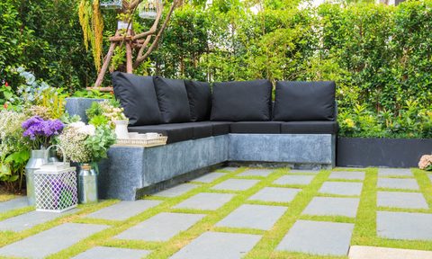 Concrete patio with grass between pavers