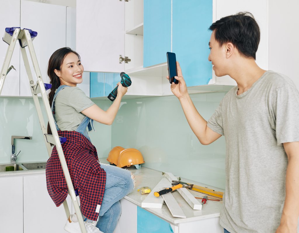 couple installing new kitchen cabinets