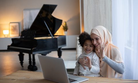 mom and child waving on video call